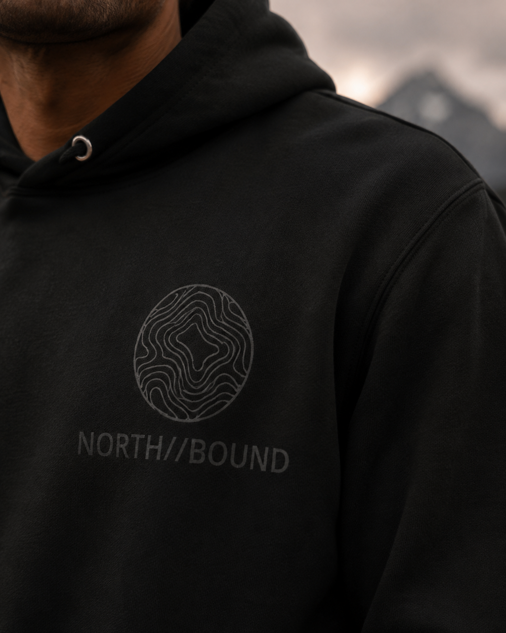 NORTH//BOUND topographic chest logo detail on Explorer Hoodie