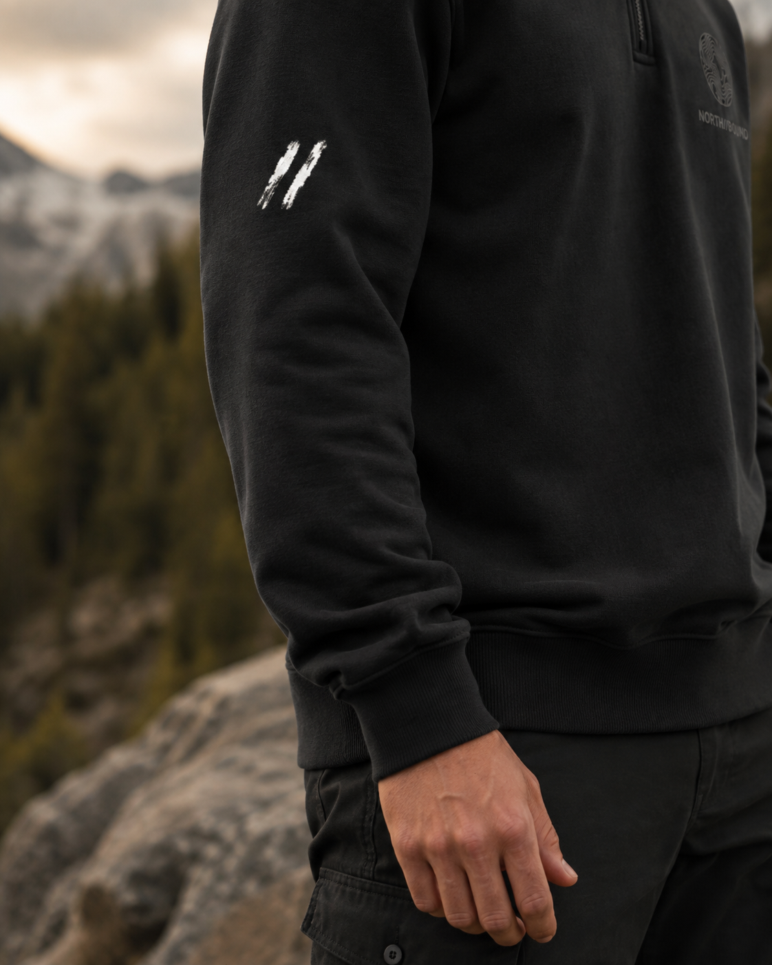 NORTH//BOUND signature sleeve detail on black quarter-zip